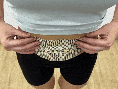 FATLAB warming body patch showing visible center color change after several hours of wear on the lower abdomen